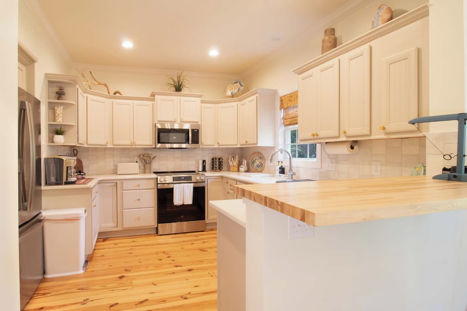 Your bright, fully-equipped kitchen features stainless steel appliances and butcher-block counters, perfect for preparing memorable meals during your stay.