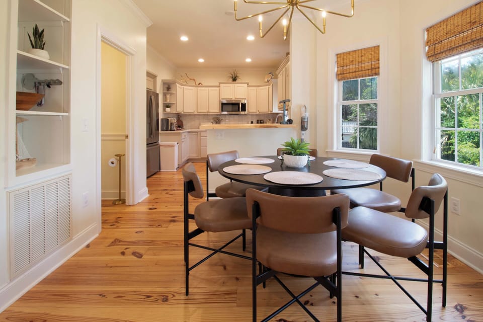 Your stylish dining area flows into a fully-equipped kitchen, perfect for memorable meals with hardwood floors and natural light.