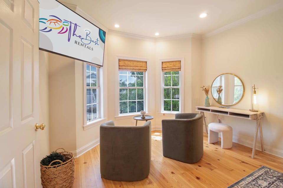 Unwind in your stylish living space with modern furnishings, warm wood floors, and natural light streaming through charming windows.