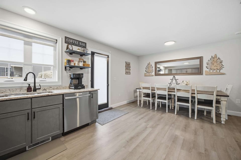 The kitchen and dining area from a wider angle, showing how naturally the two spaces connect for group cooking and meals.