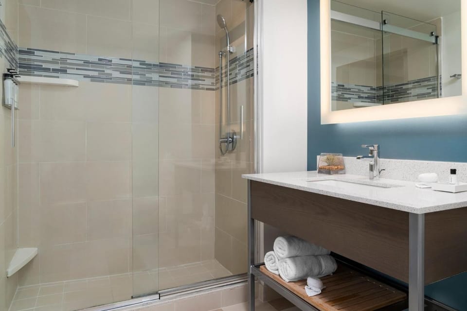 Enjoy an airy bath space with modern fixtures and storage.