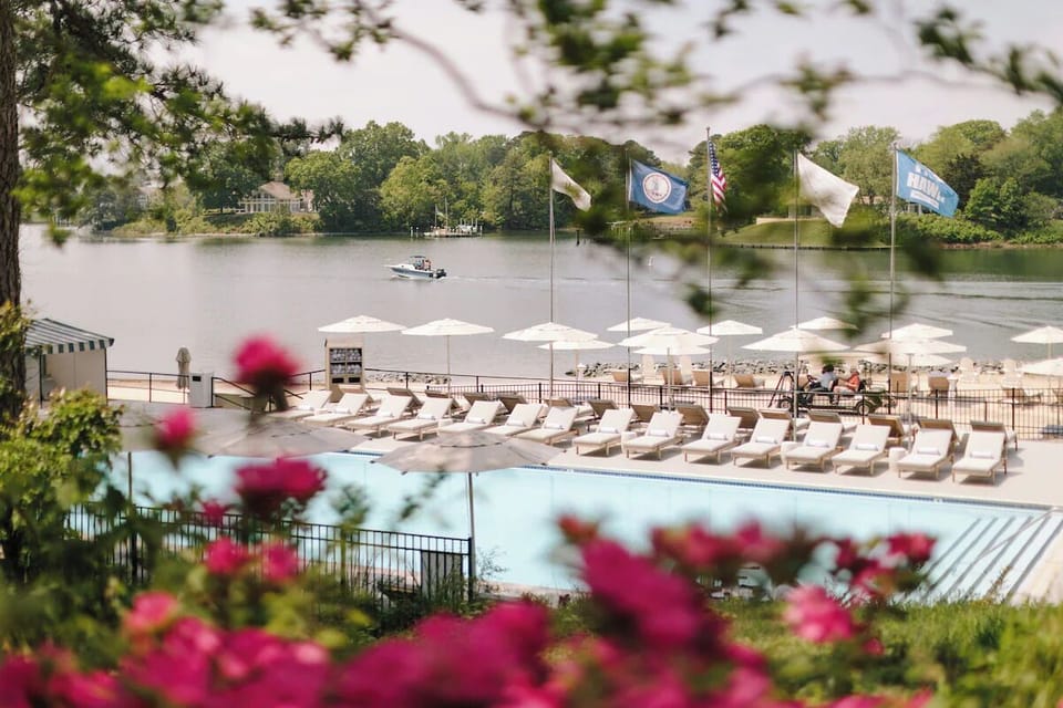 Wander into a serene poolside garden with waterfront views.