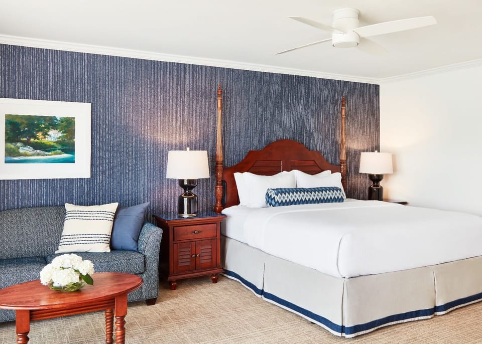 Sink into plush bedding framed by classic coastal elegance.