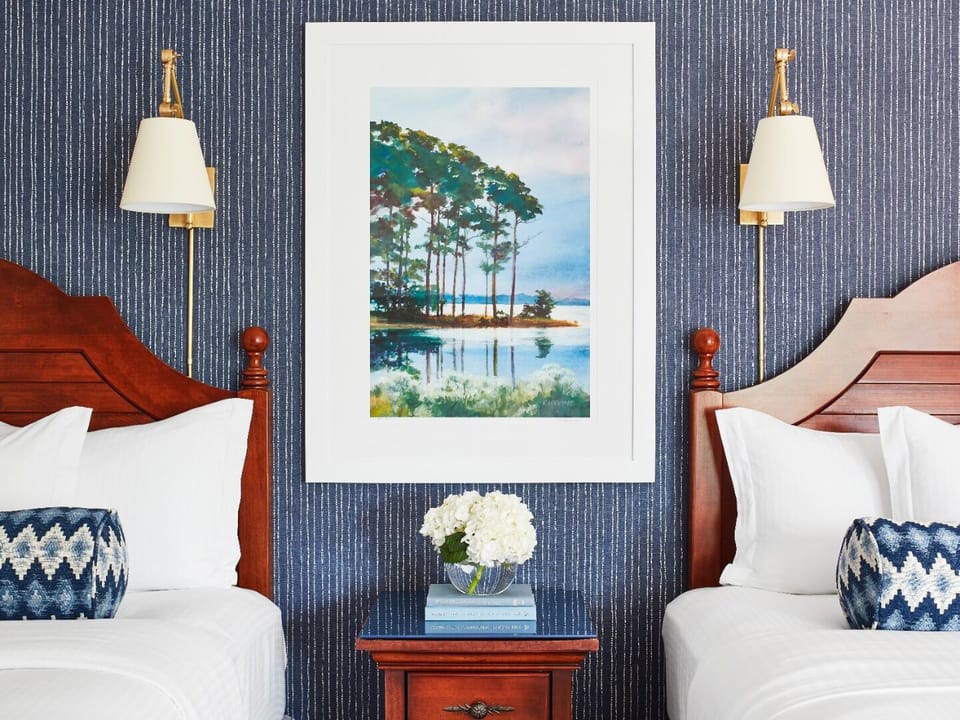 Drift off between crisp linens and calming coastal artwork.