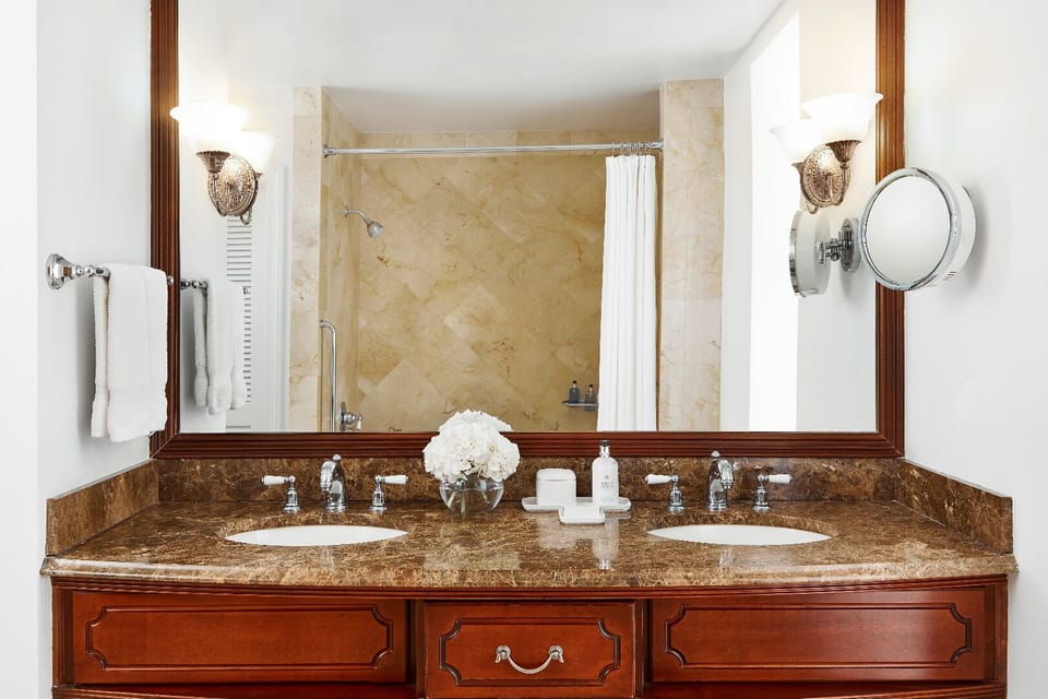 Refresh at the double vanity with plush towels and bright lighting.