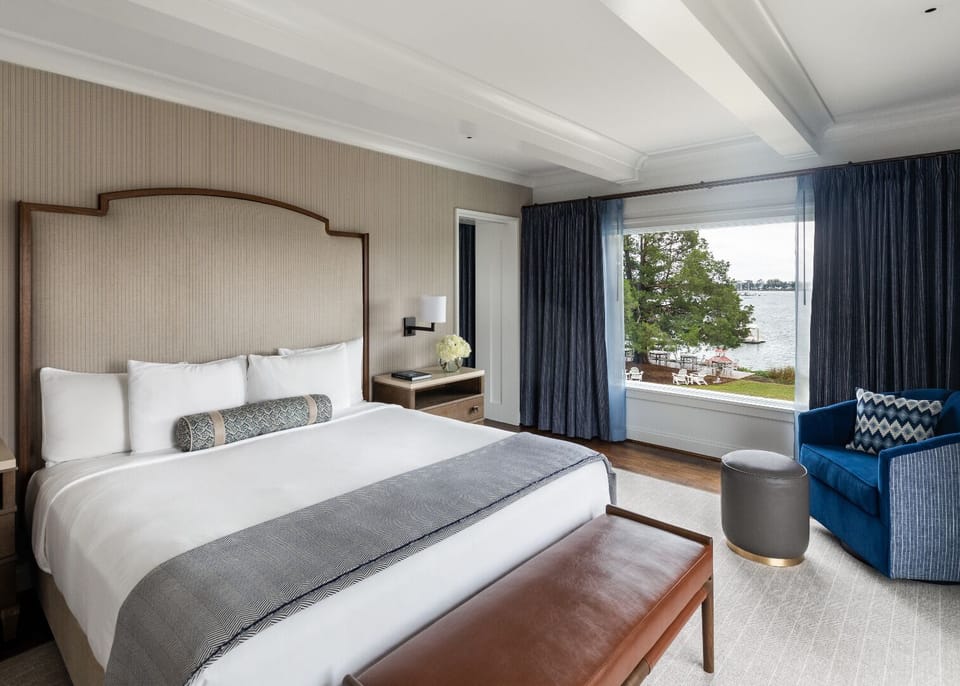 Stretch out in a serene king bed beside calming waterfront views.