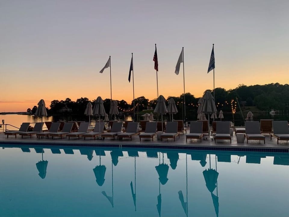 Unwind at sunset as the pool mirrors a glowing sky.