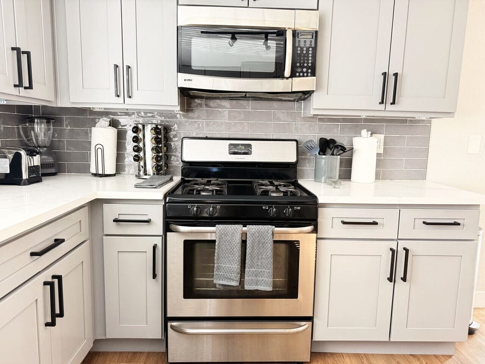 Your perfect home-cooked meal starts here. This well-appointed kitchen offers ample counter space and modern finishes, providing an inviting atmosphere for prepping morning coffee or a full family dinner during your getaway.