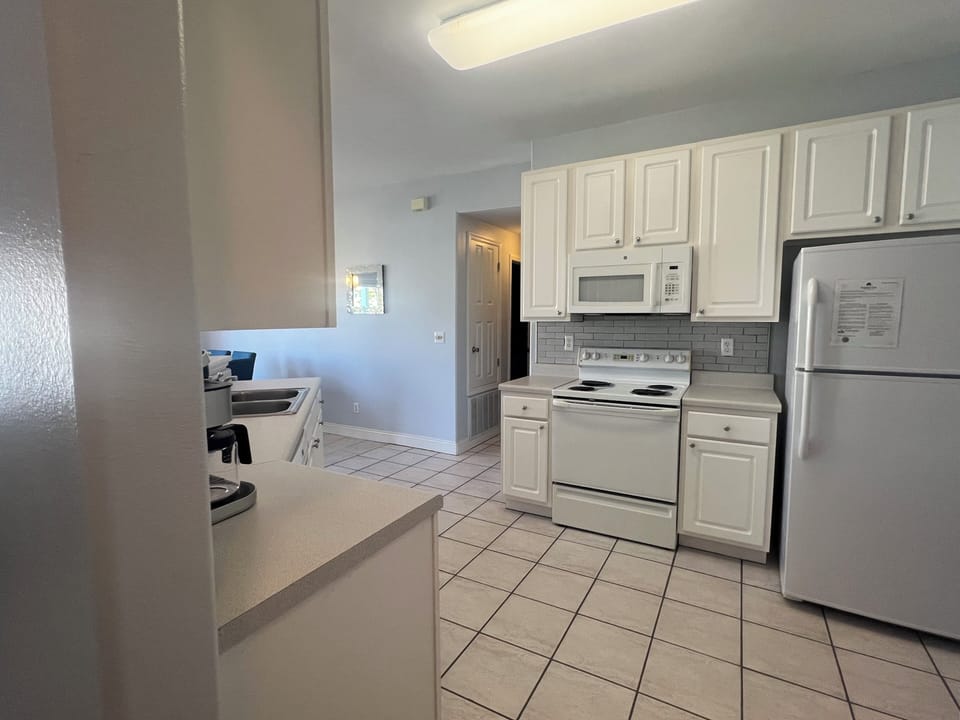 Your fully equipped kitchen features white cabinets, modern appliances, and everything you need to prepare home-cooked meals during your stay.