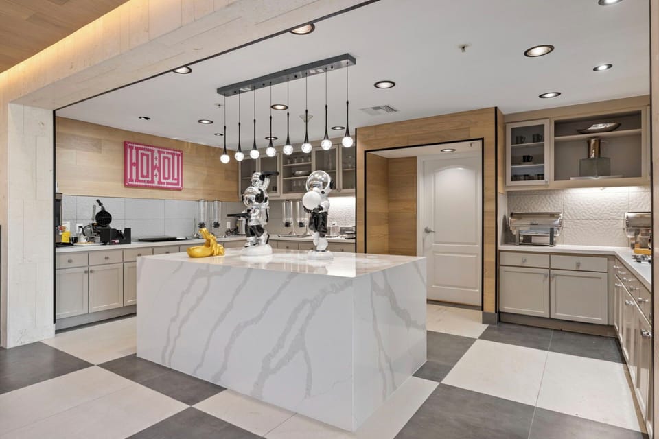 Cook and mingle around the luxe island with warm lighting.