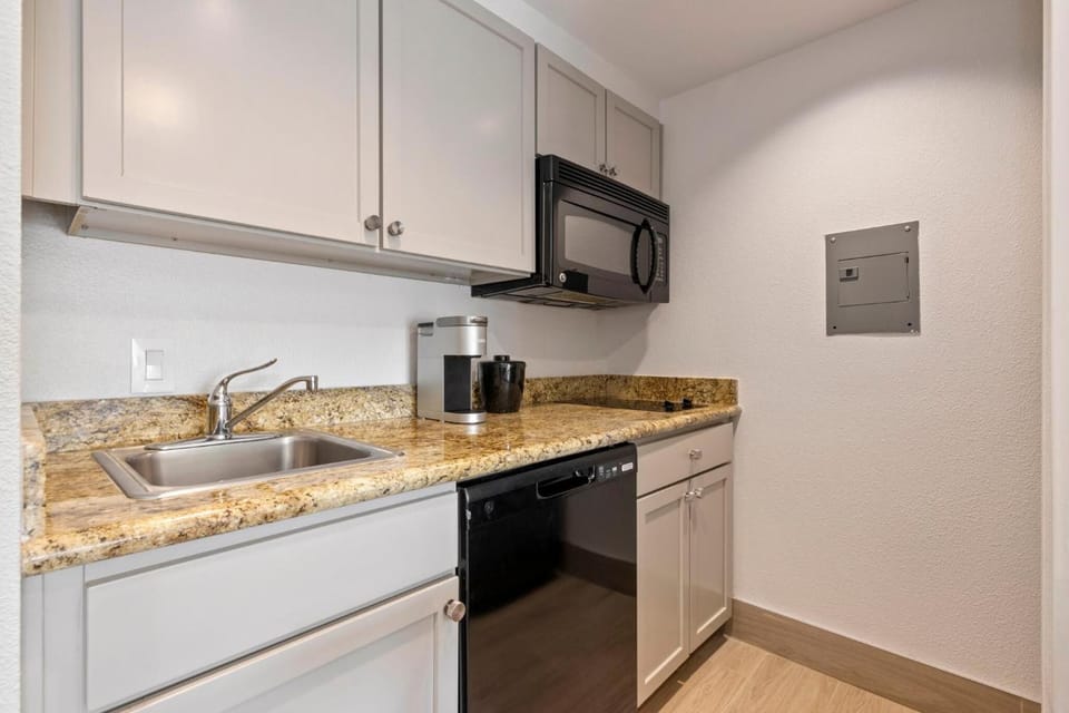 Brew morning coffee and prep snacks on granite counters.
