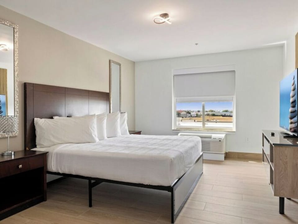 Relax in a sunlit king room with TV and views.