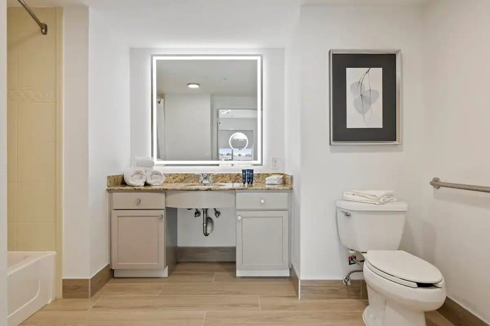 Refresh at the bright vanity with plush towels ready.