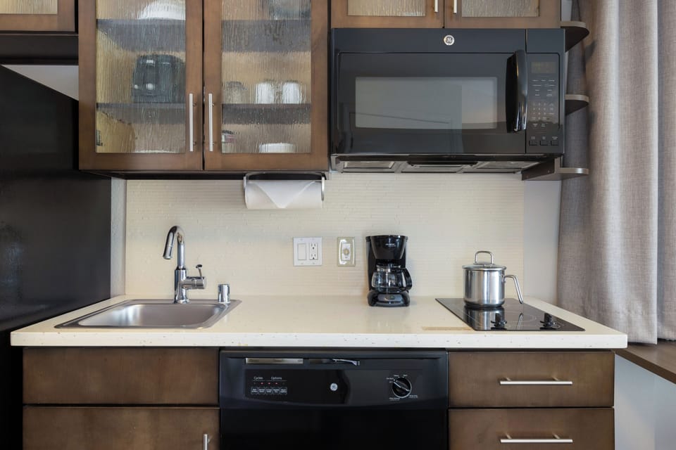 Brew coffee and prep meals with sink, stove, and microwave.