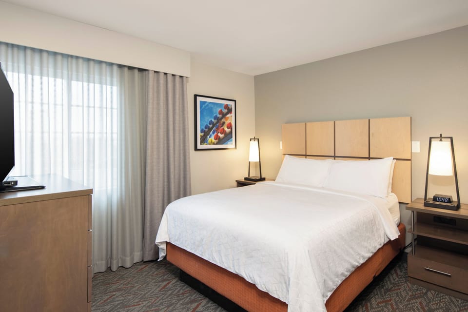 Unwind into crisp linens and soft, calming bedside light.
