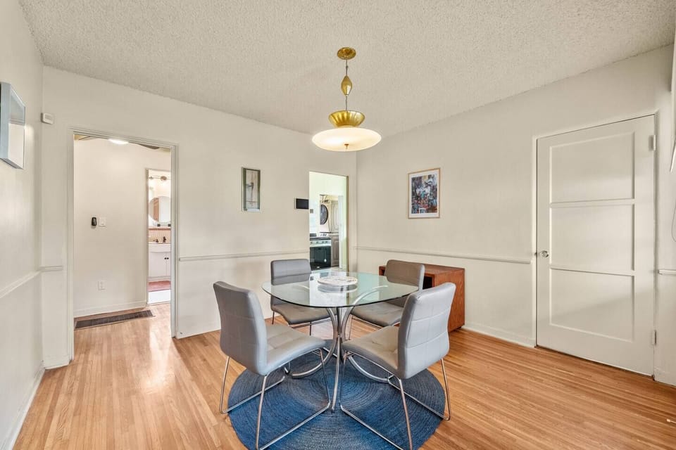 Intimate dining space with a glass table seating four.
