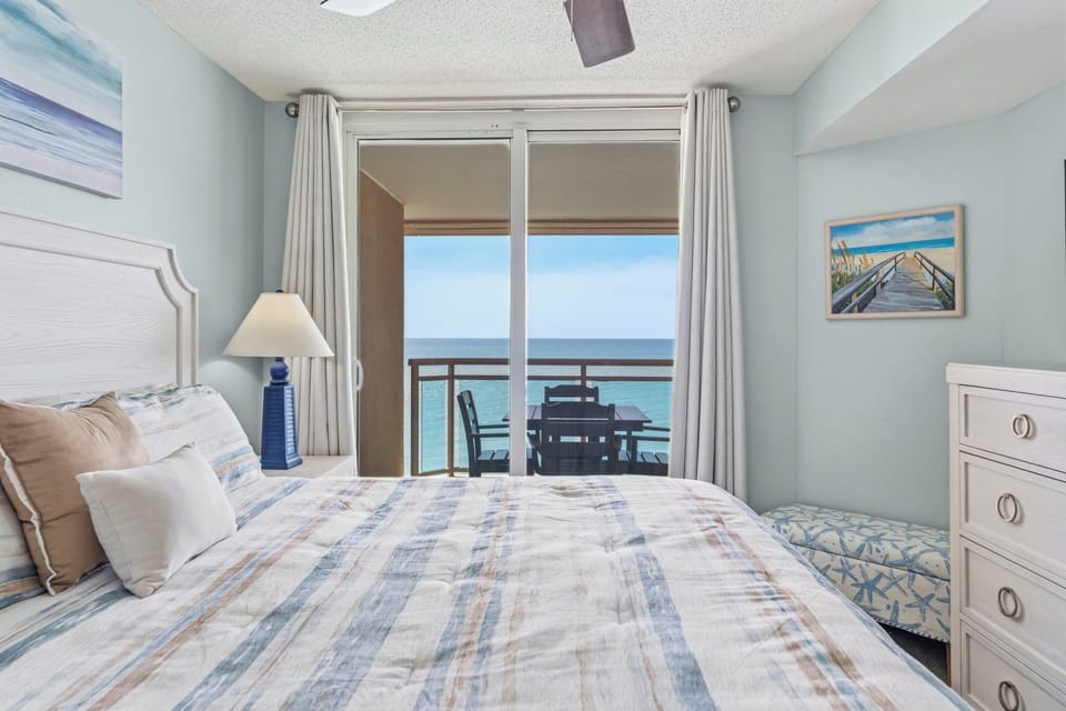 Primary Bedroom with King Bed, ensuite bathroom, and balcony with direct oceanview