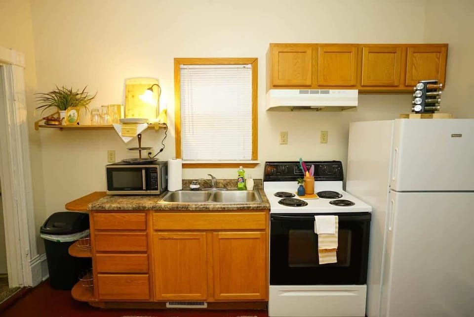 Full kitchen with stove, microwave, and fridge