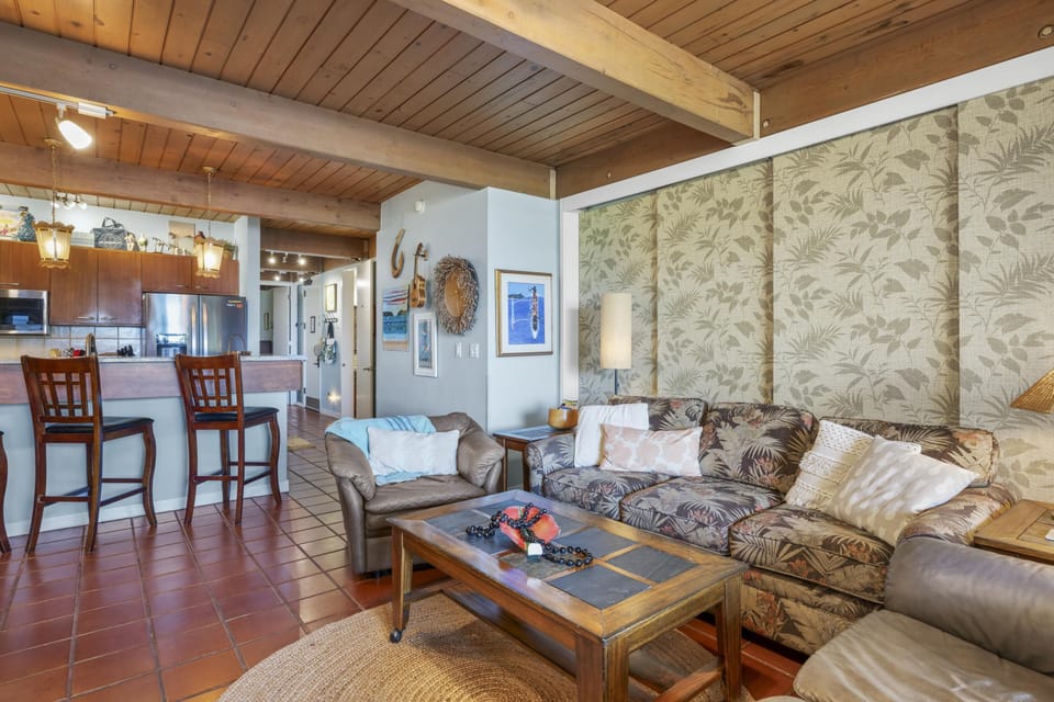 Cozy living room with rustic hawaiian charm and open kitchen access