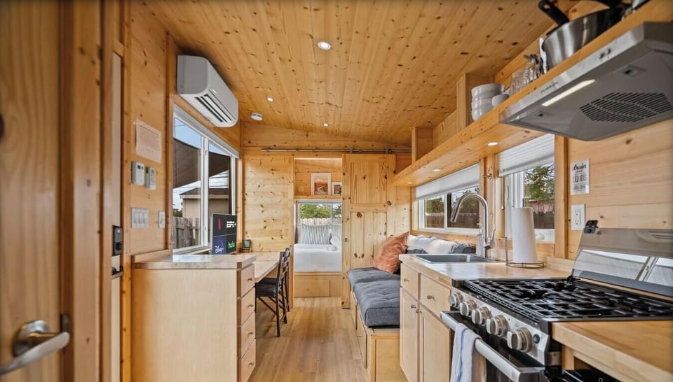The casita features a full kitchenette with gas stove, microwave, mini fridge, and a cozy dining nook built right in.