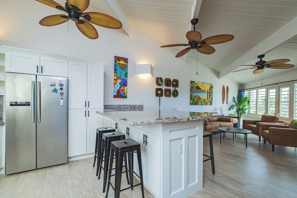 Bright, open-concept kitchen with granite countertops, stainless steel appliance