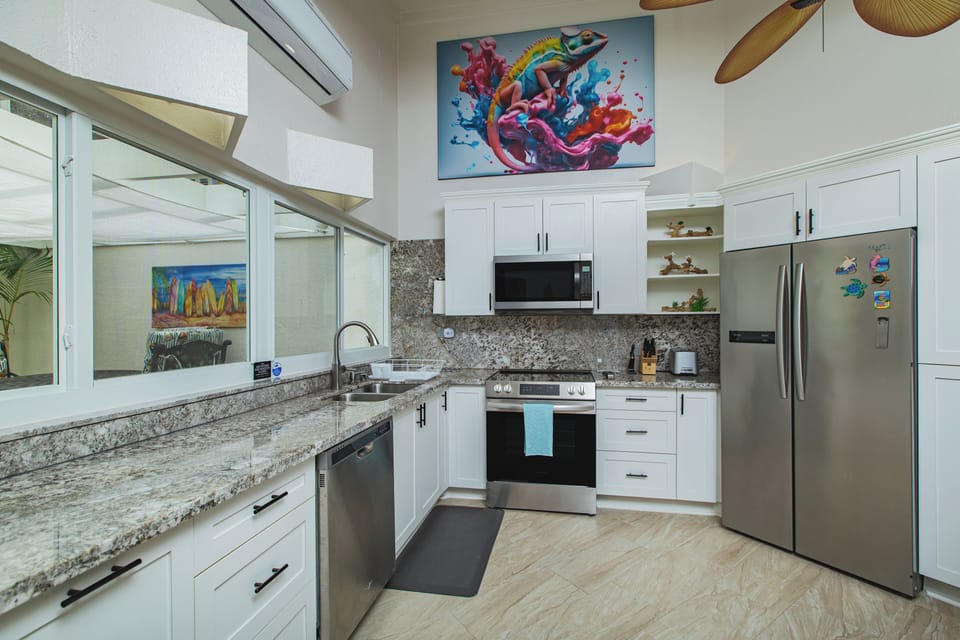 Cook in the kitchen, while having a conversation with guests in the atrium.
