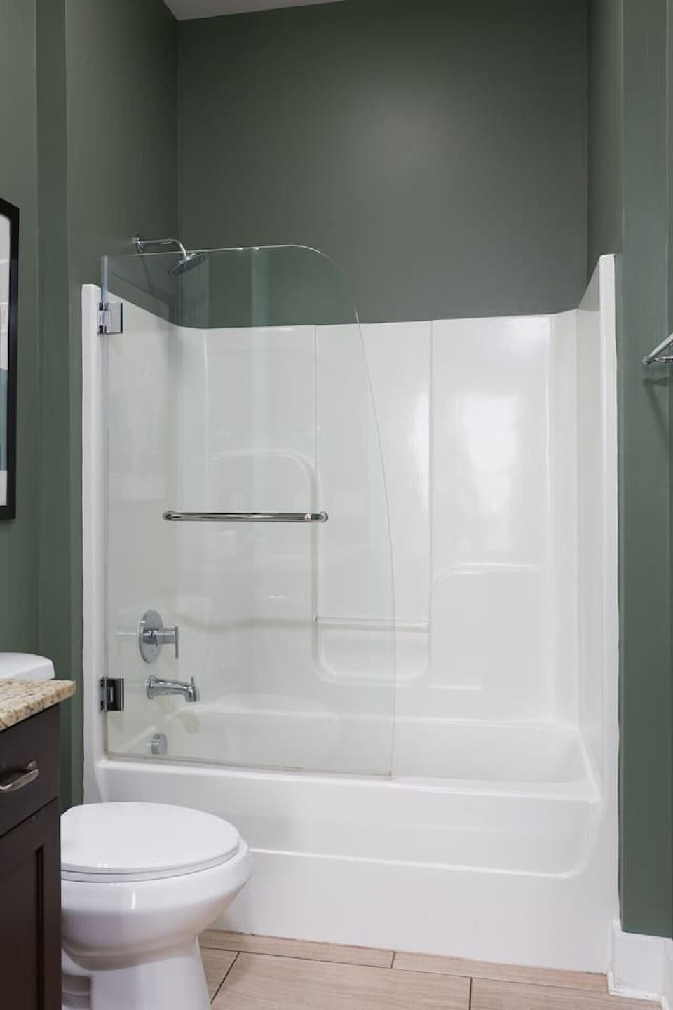 Full-size ensuite bathroom with a shower/tub combo and ample counter space to get ready.