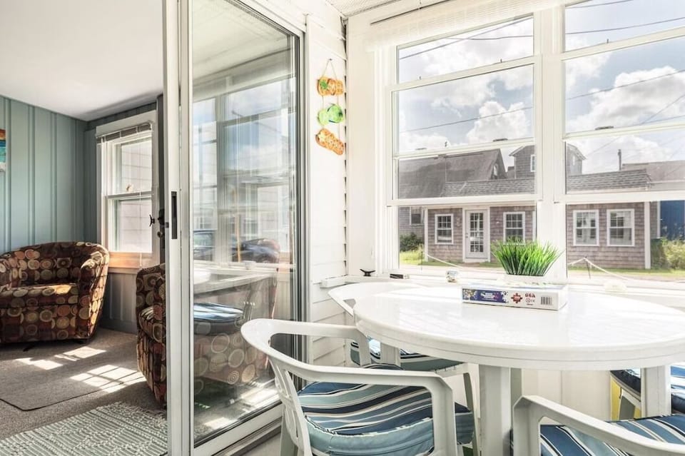Sun porch featuring a dining table and 4 chairs as well as a day bed