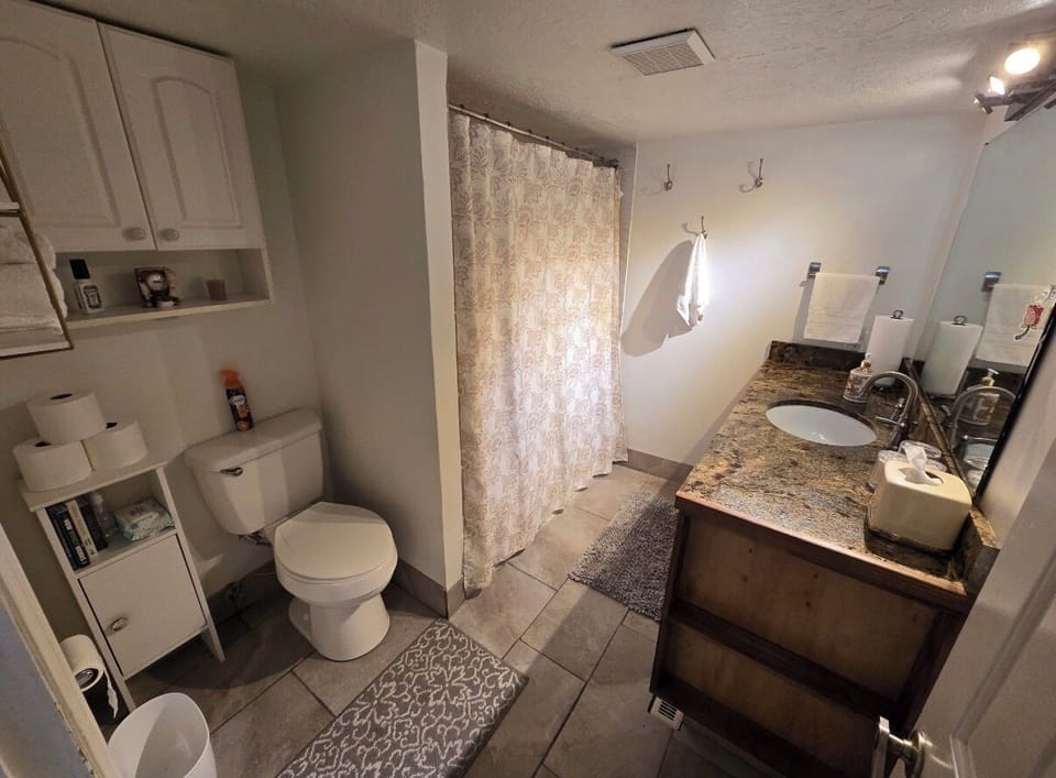 Bathroom tub shower and lots of storage