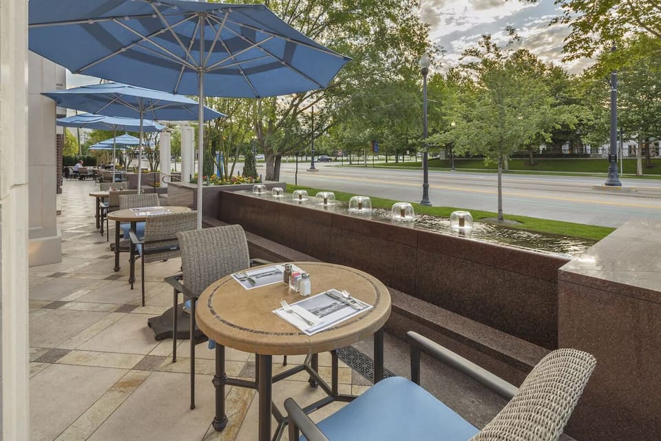 Sip morning coffee on the sunny patio under umbrellas.