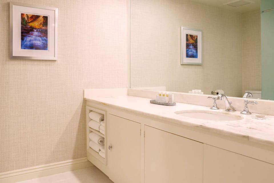 Refresh at the bright vanity with plush towels ready.