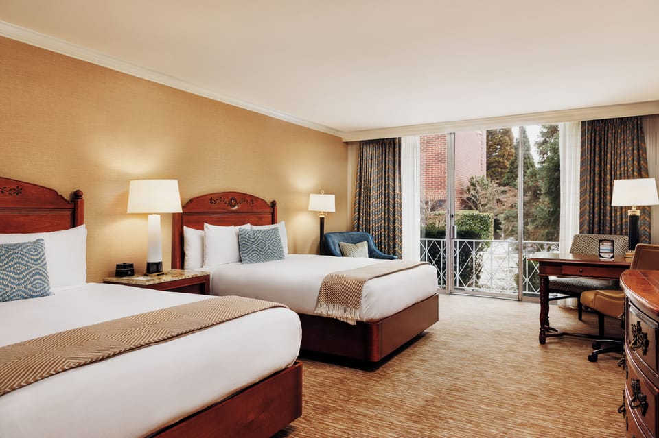 Relax in crisp linens, surrounded by soft, warm bedside lighting.