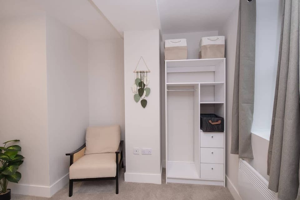 A comfortable bedroom with king size bed, perfect for unwinding after a long day. Featuring a spacious wardrobe to store all your belongings, the room offers a calm and restful atmosphere for a peaceful night’s sleep.