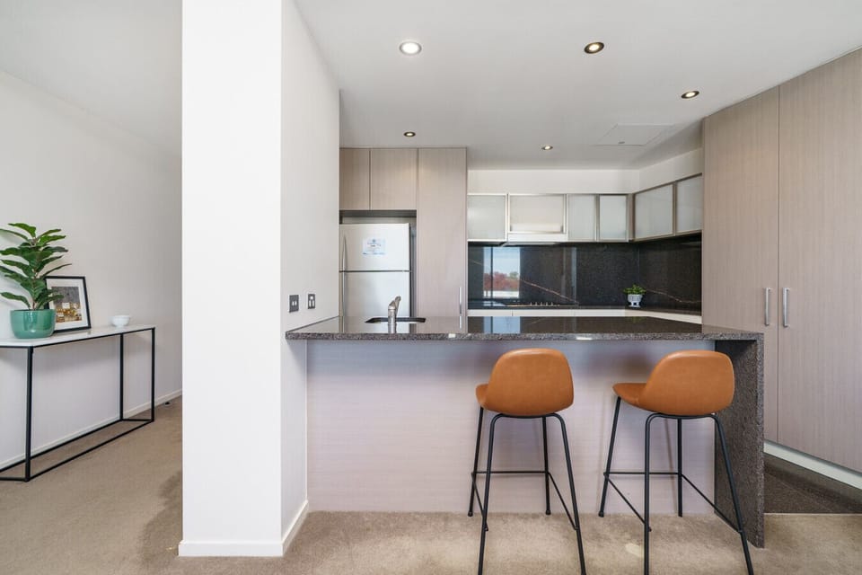 Enjoy casual meals or your morning coffee at the breakfast bar in this bright, modern kitchen space.