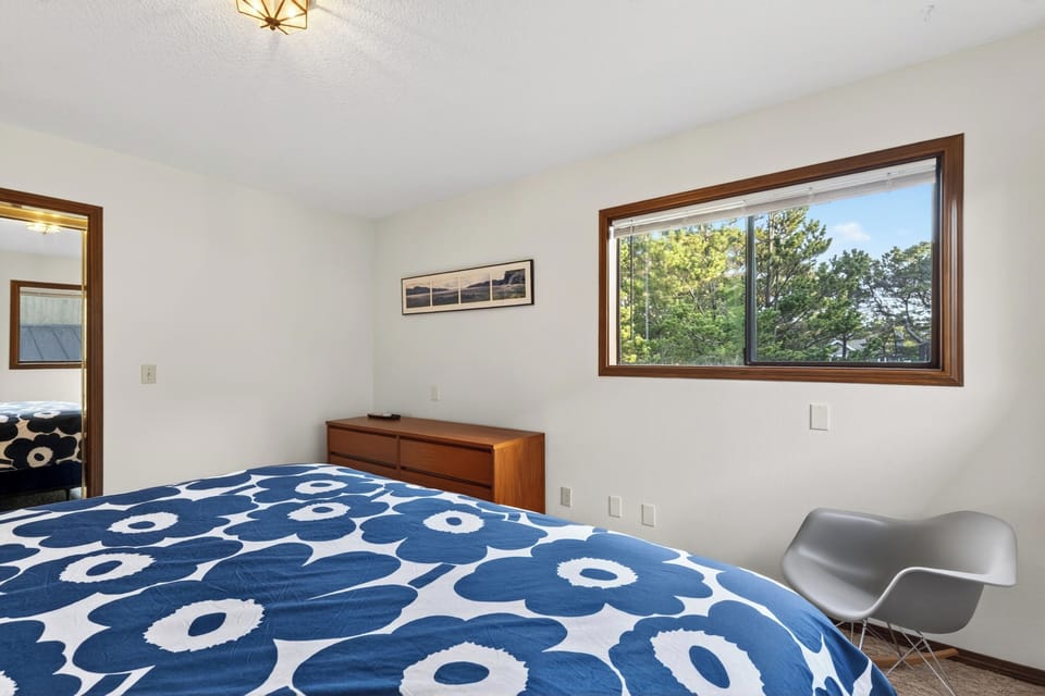 Primary bedroom with a large window.