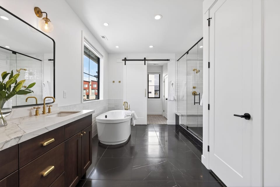 The primary bedroom's ensuite features a shower and a soaking tub.