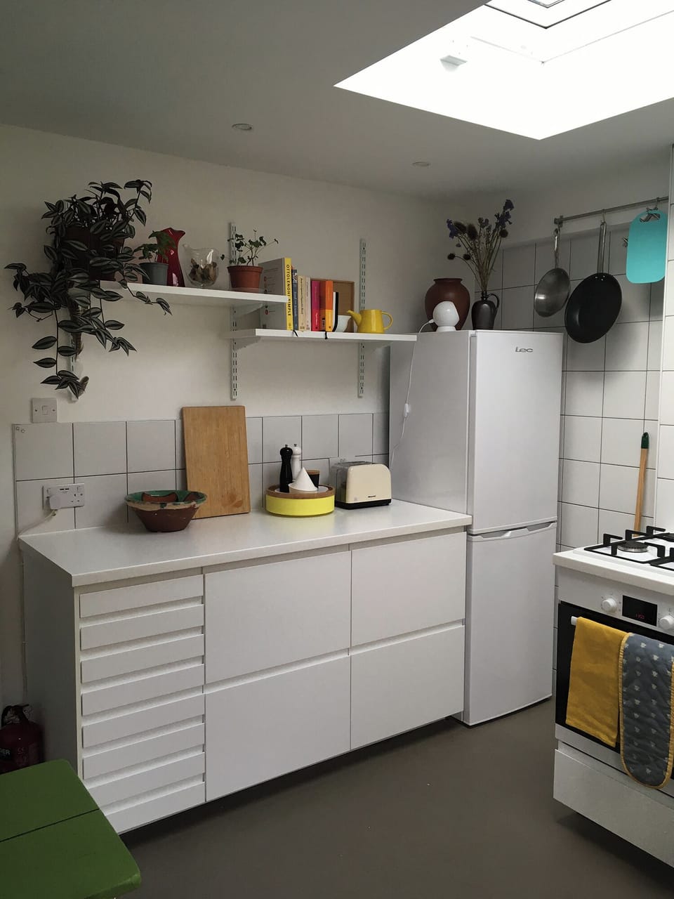 Kitchen showing fridge, cooker and storage