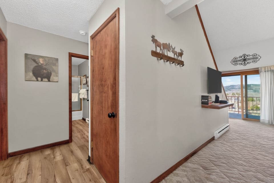Your cozy retreat features warm wood details, mountain views through large windows, and rustic charm throughout.