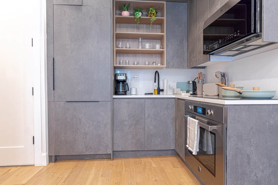 Modern kitchen with open shelving and sleek, fully equipped setup