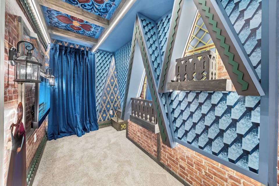 Experience a uniquely designed space with striking blue walls and vibrant ceilings. Rich textures from the curtains and brick accents create a warm, inviting atmosphere perfect for your relaxation.