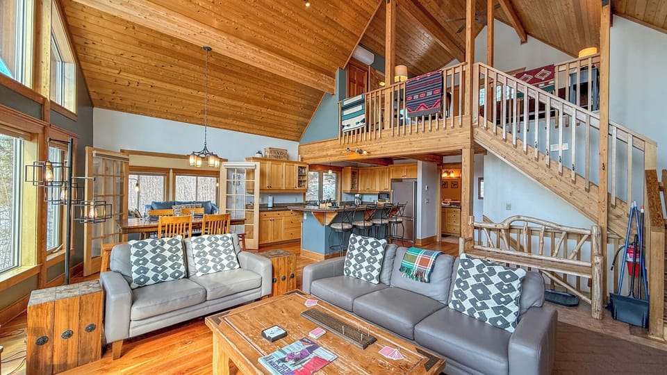 Your mountain retreat awaits with soaring timber ceilings, cozy leather seating, and a full kitchen perfect for gathering after adventure-filled days.