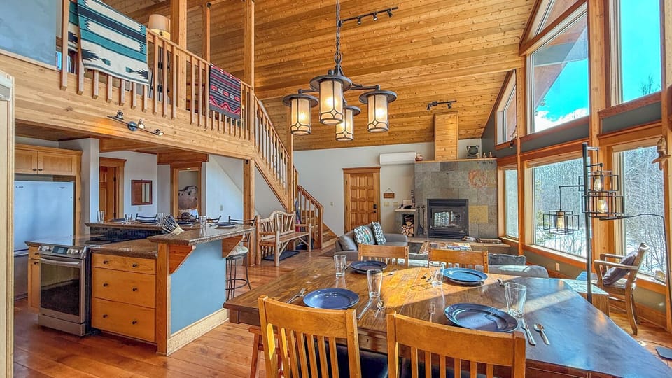 Your mountain cabin features soaring ceilings, a stone fireplace, and open-concept living where you'll gather for meals and cozy evenings together.
