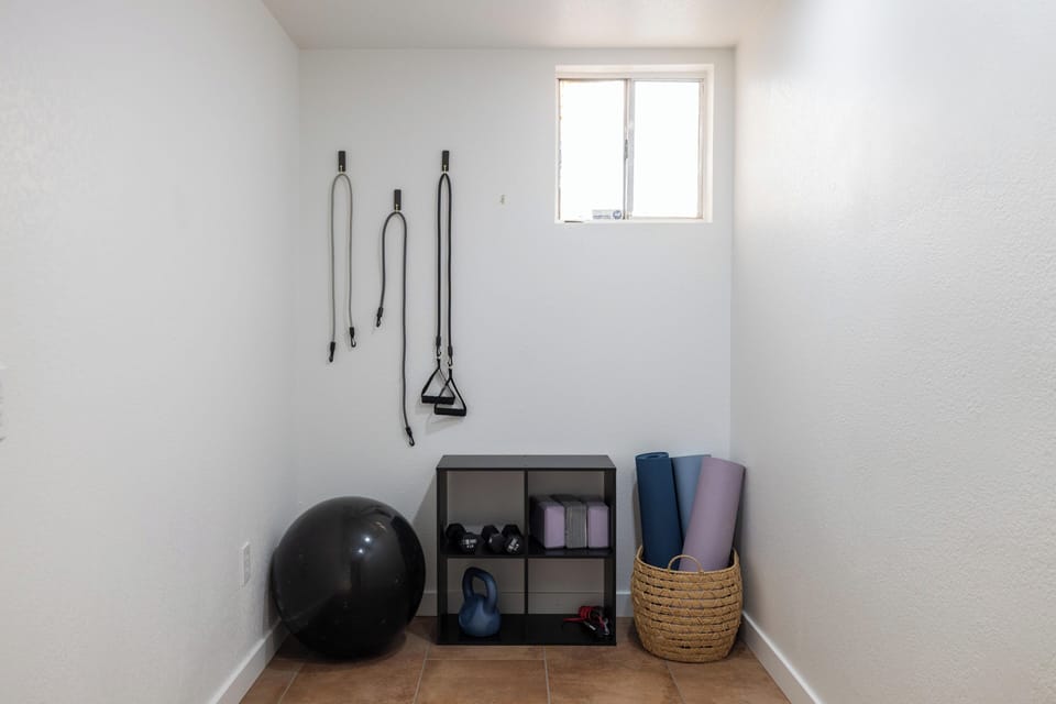 Your private workout space awaits with resistance bands, yoga mats, weights, and a stability ball