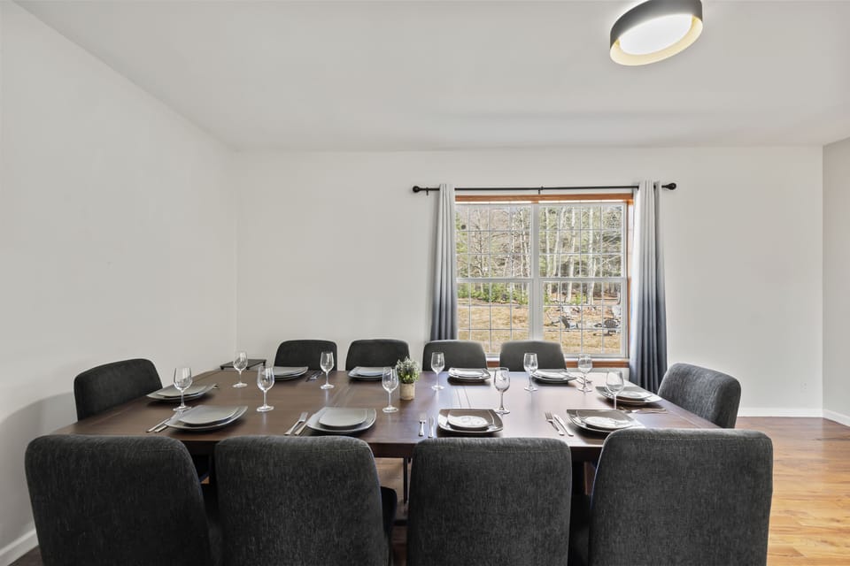Bright dining room seats 10, wooded views—perfect for group meals.
