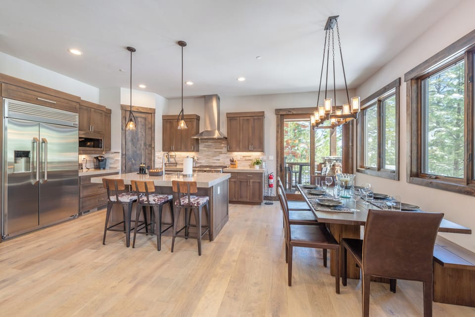 Your open-concept kitchen and dining space features warm wood finishes, stainless appliances, and a welcoming island perfect for gathering with loved ones.