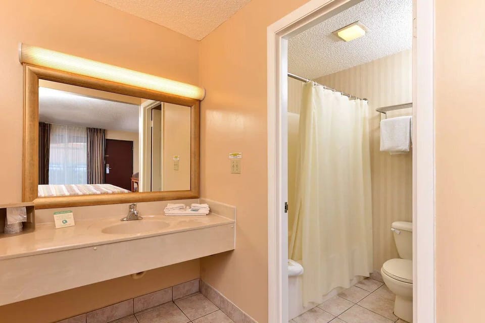 Refresh easily with a bright vanity and clean shower-tub combo.