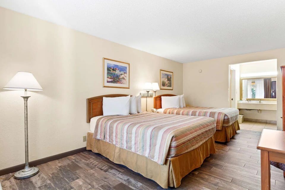Drift off comfortably with two plush beds and soft lighting.