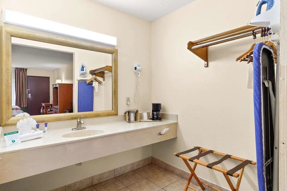 Get ready effortlessly with a wide vanity and handy storage.