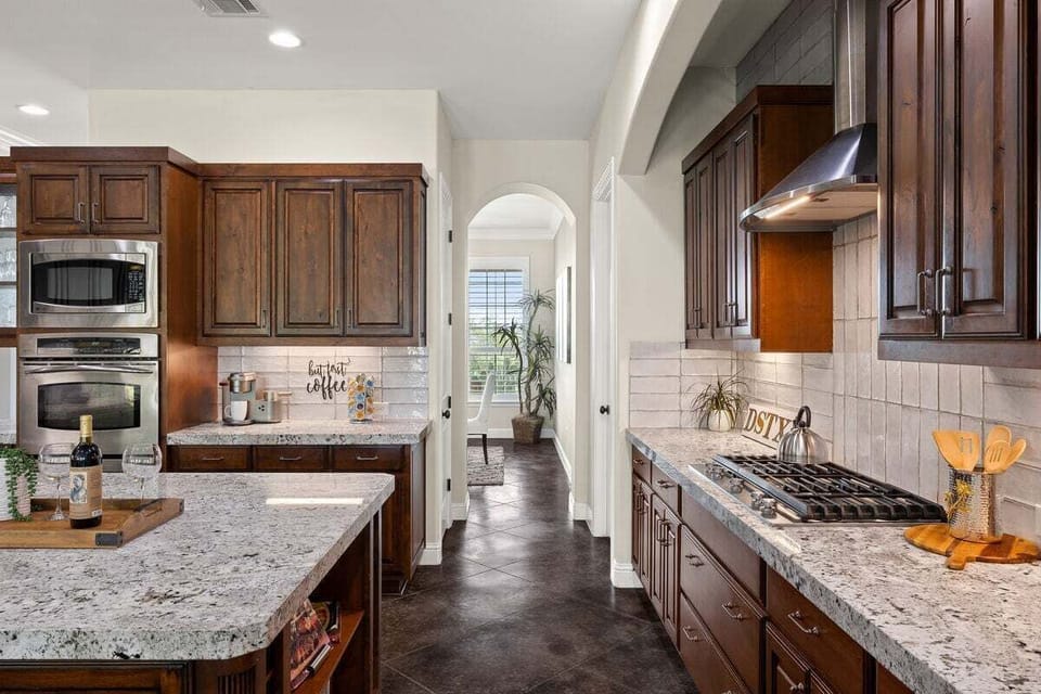 Gather around the kitchen island, which serves as the central hub for culinary delights and socializing.