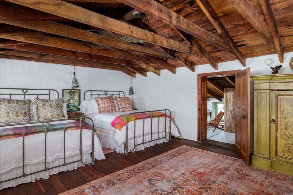 Retreat to the charming ambiance of this bedroom, featuring two double beds, ideal for a family or group of friends.